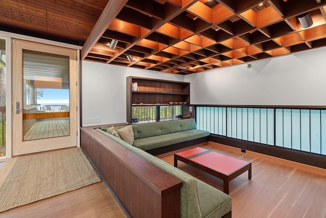 living area with coffered ceiling, wood finished floors, and a wealth of natural light