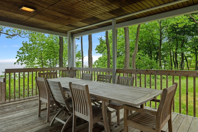 wooden terrace featuring outdoor dining area