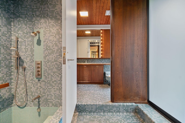 full bath with wooden ceiling, tiled shower, and vanity