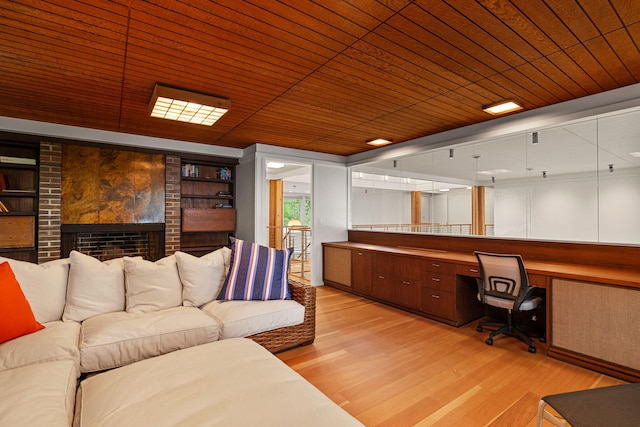 office area featuring built in desk, light wood-type flooring, and wooden ceiling