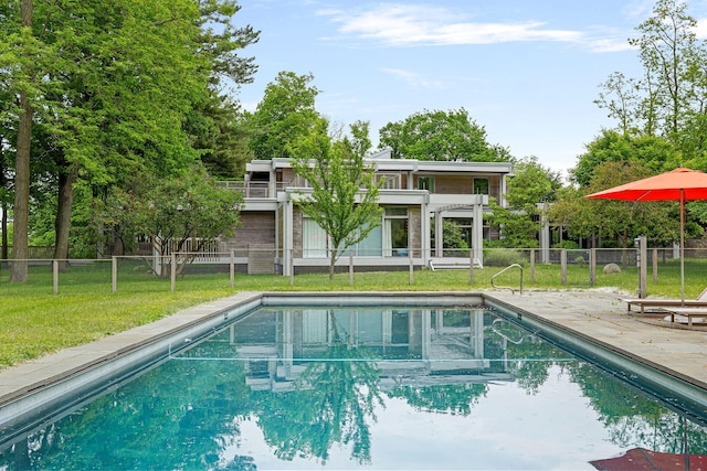 view of swimming pool with a yard, a patio, fence, and a fenced in pool