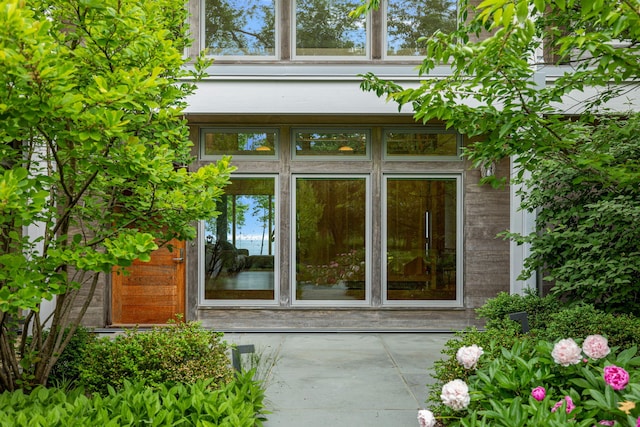 view of exterior entry with a patio area