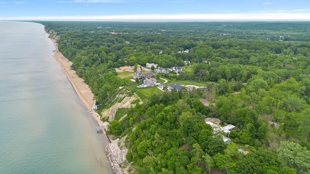 aerial view with a water view and a forest view