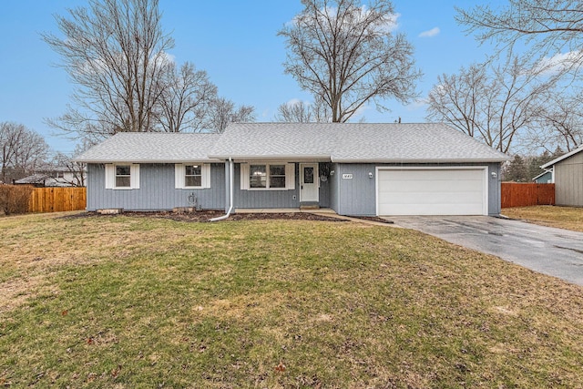 ranch-style home featuring a garage, a shingled roof, fence, driveway, and a front lawn