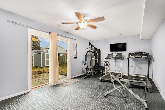 workout area featuring ceiling fan, carpet floors, and baseboards