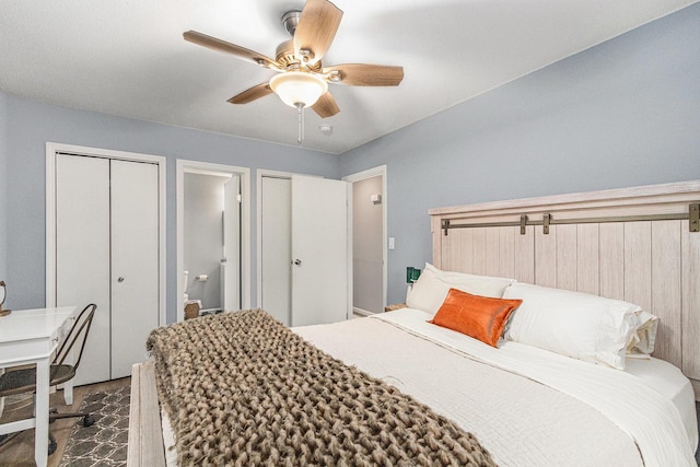 bedroom with a ceiling fan and multiple closets