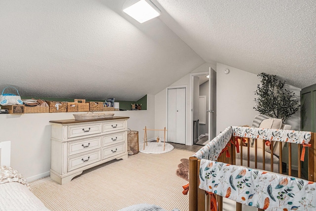 bedroom featuring lofted ceiling, light carpet, a textured ceiling, and baseboards