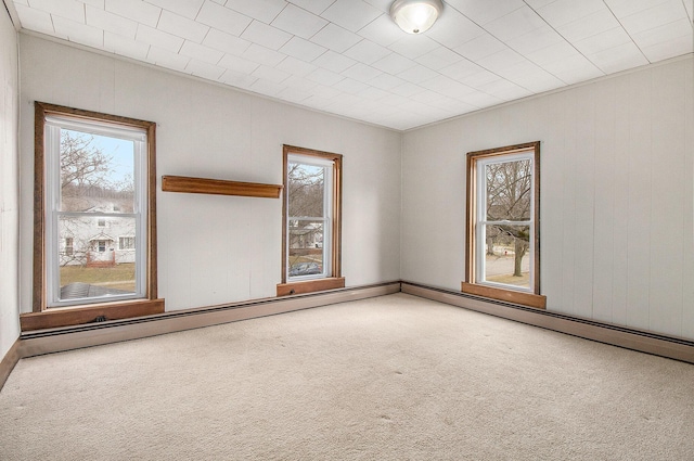 carpeted spare room featuring plenty of natural light