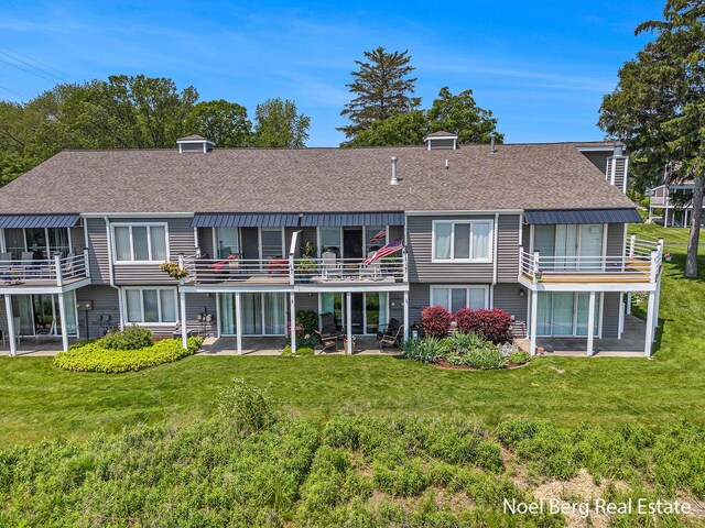 606 Edgewater Ct, Spring Lake, MI 49456 - back of house with roof with shingles, a lawn, and a balcony