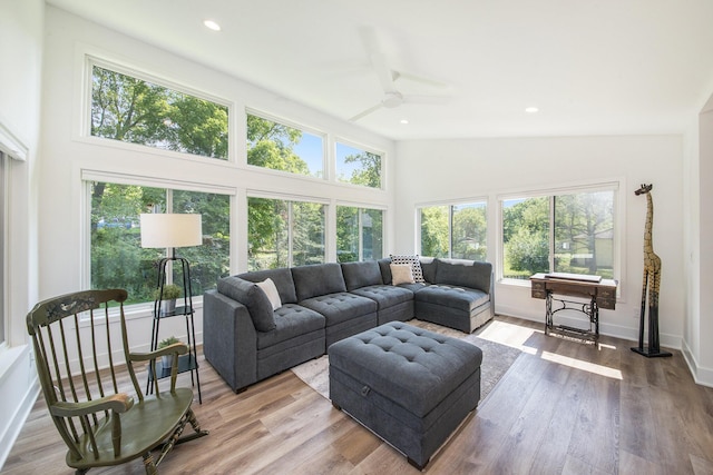 living area featuring recessed lighting, ceiling fan, wood finished floors, high vaulted ceiling, and baseboards