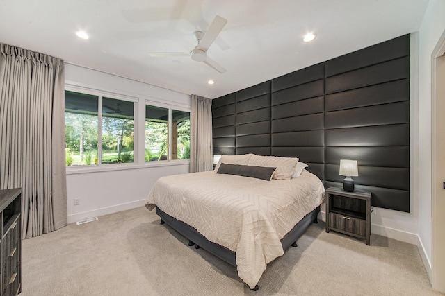 bedroom with light carpet, recessed lighting, visible vents, and baseboards