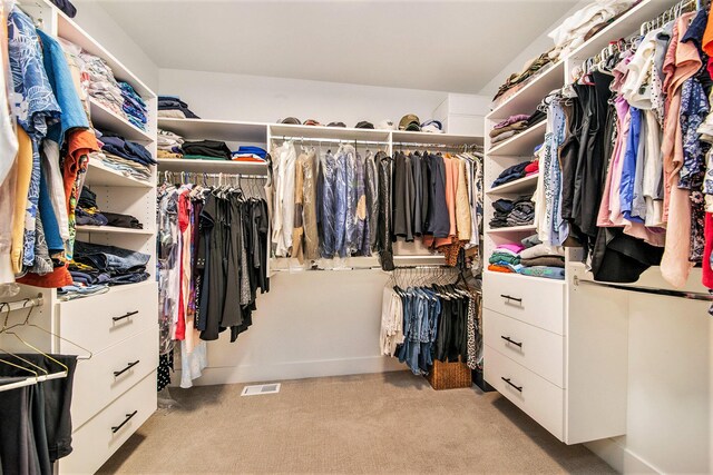 spacious closet featuring visible vents and light colored carpet