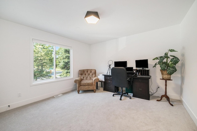 carpeted home office featuring visible vents and baseboards