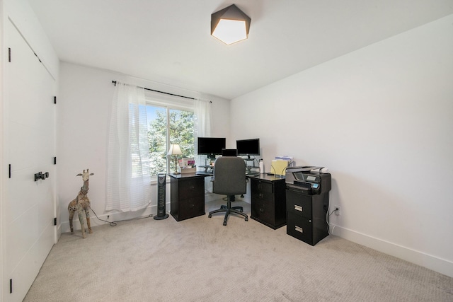 carpeted home office with baseboards