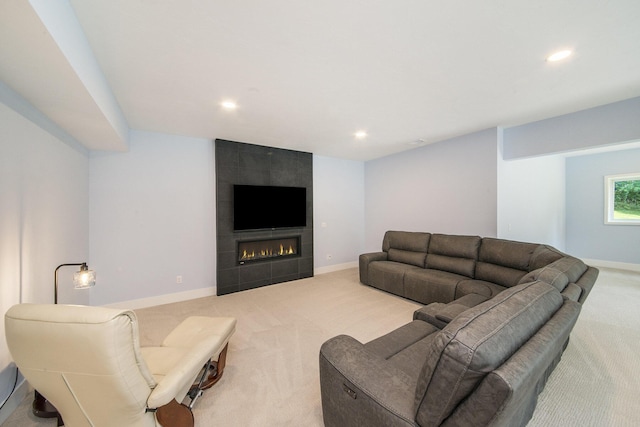 carpeted living room with a tile fireplace, baseboards, and recessed lighting