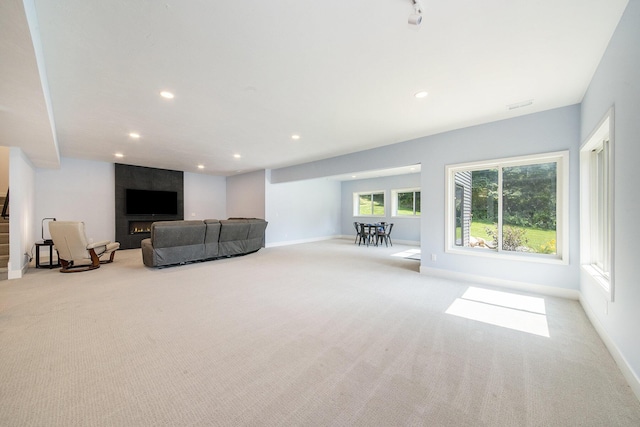 unfurnished living room featuring baseboards, carpet floors, and recessed lighting