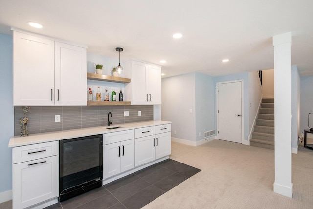 bar with wine cooler, indoor wet bar, visible vents, backsplash, and stairs