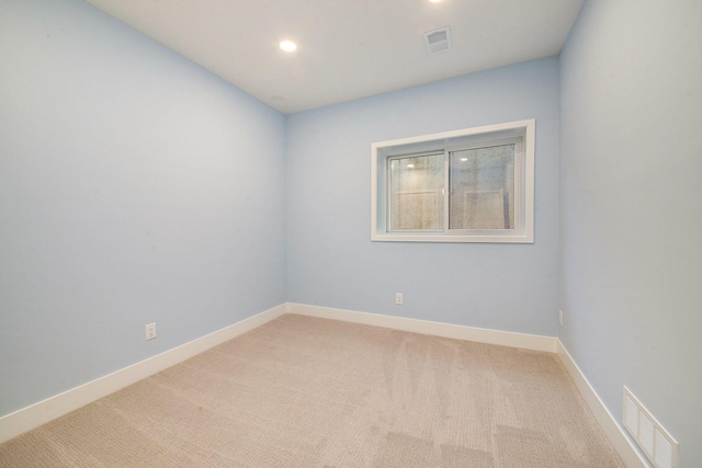 empty room with light carpet, recessed lighting, visible vents, and baseboards