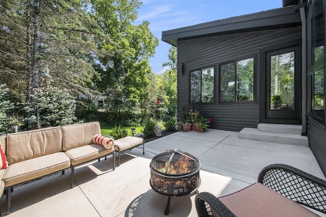 view of patio / terrace with an outdoor living space with a fire pit