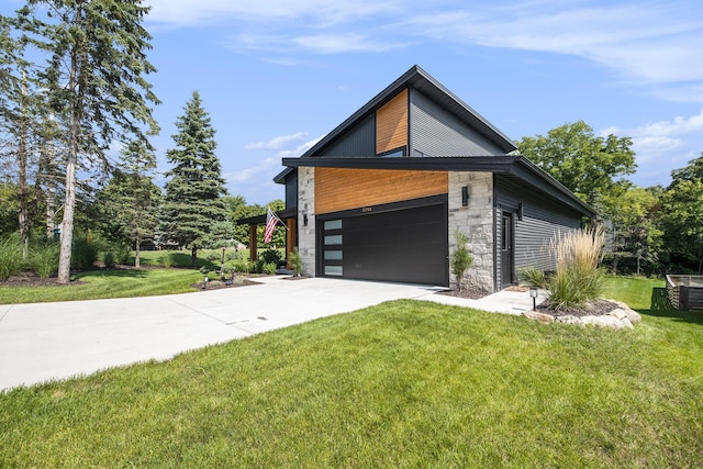 view of side of property with stone siding, a lawn, and driveway