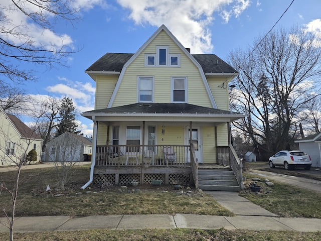 dutch colonial with a porch, a gambrel roof, and a shingled roof