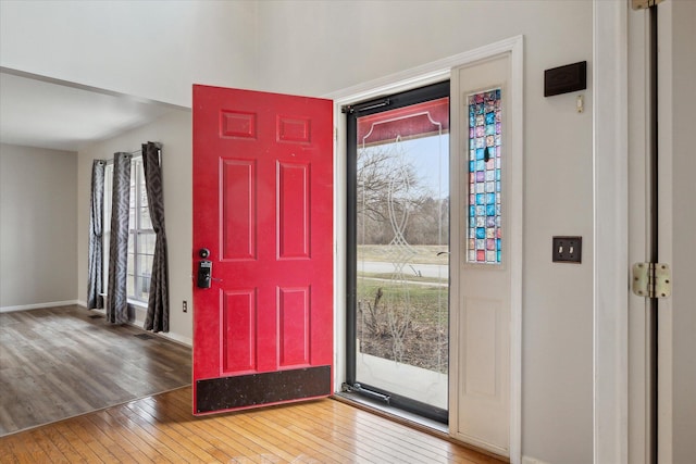 foyer featuring wood-type flooring and baseboards