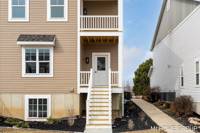 doorway to property with cooling unit and a balcony