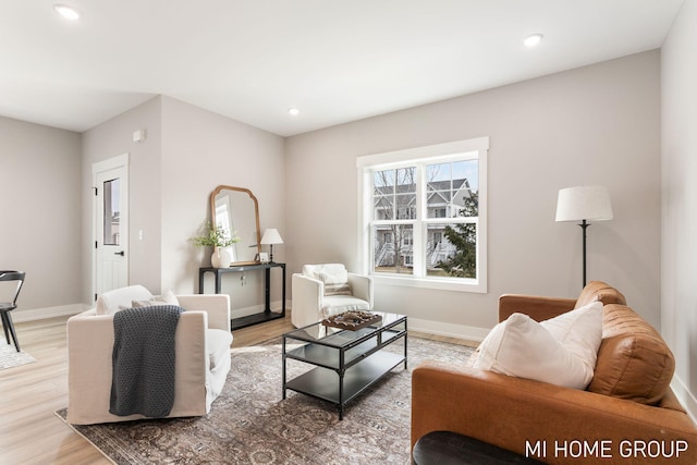 living room with recessed lighting, light wood-style flooring, and baseboards