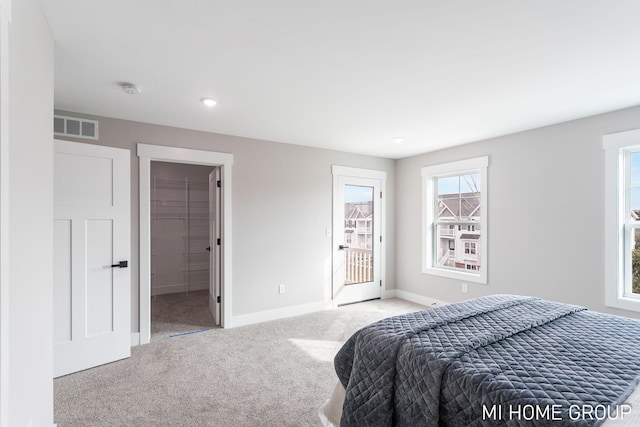 carpeted bedroom featuring visible vents, baseboards, and access to outside