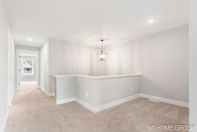 corridor with an inviting chandelier, recessed lighting, carpet, and baseboards