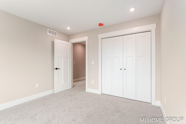 unfurnished bedroom with recessed lighting, visible vents, carpet flooring, and baseboards