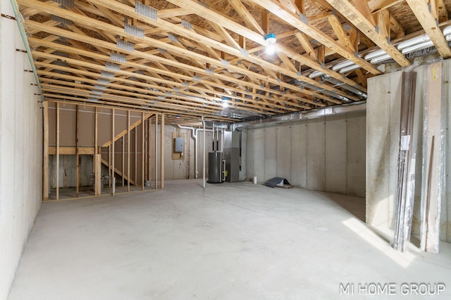 below grade area featuring water heater and electric panel