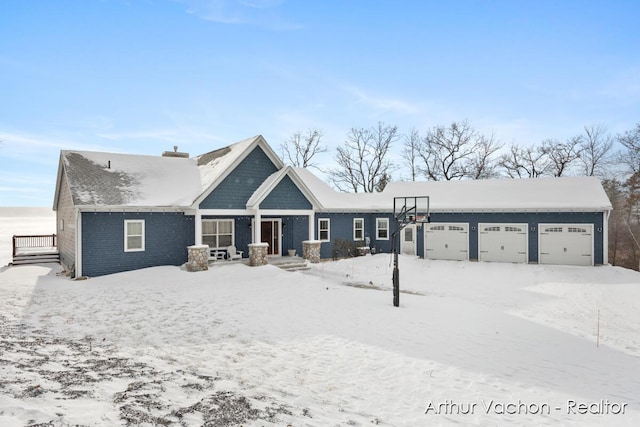 craftsman-style house featuring a chimney and an attached garage