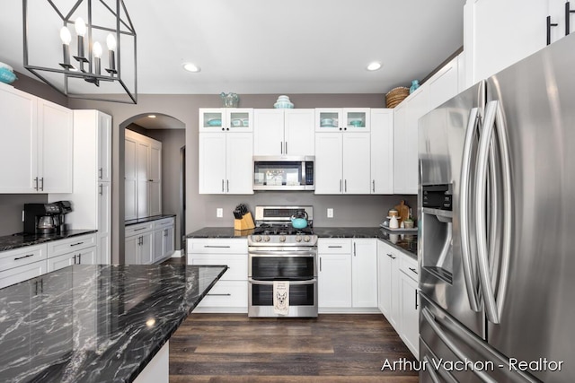 kitchen featuring appliances with stainless steel finishes, dark wood finished floors, white cabinets, and glass insert cabinets