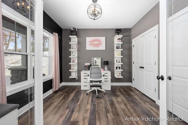 office space featuring dark wood-style flooring, baseboards, and an inviting chandelier