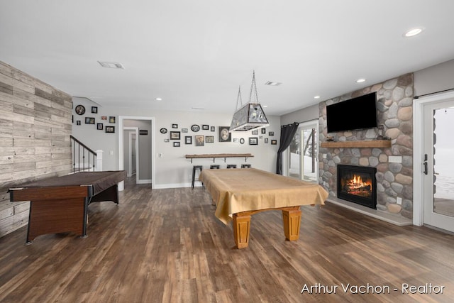 game room with wooden walls, visible vents, wood finished floors, pool table, and a fireplace