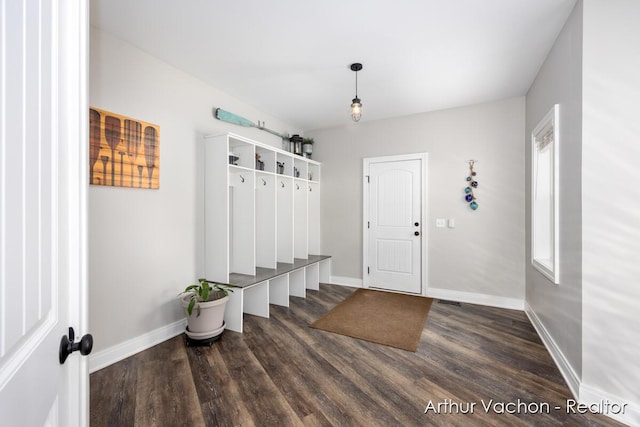 mudroom with dark wood-style flooring and baseboards