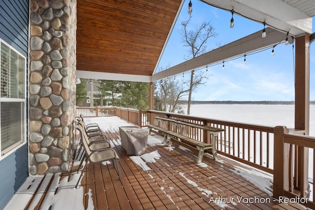 wooden terrace with a water view and grilling area