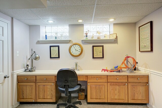 home office featuring a paneled ceiling, built in desk, and recessed lighting