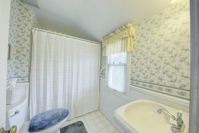 full bathroom featuring toilet, wallpapered walls, and tile patterned flooring