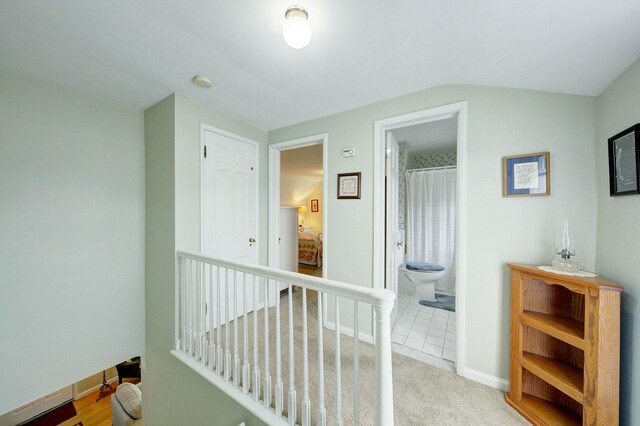 hallway featuring baseboards and an upstairs landing