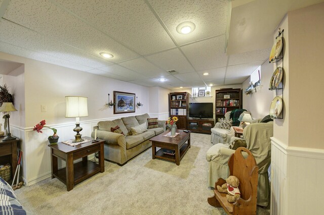 carpeted living area featuring recessed lighting, a wainscoted wall, a paneled ceiling, and visible vents