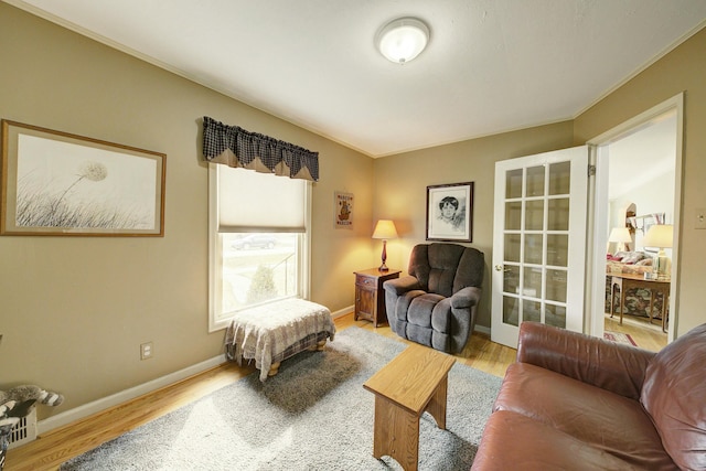 sitting room featuring baseboards and wood finished floors