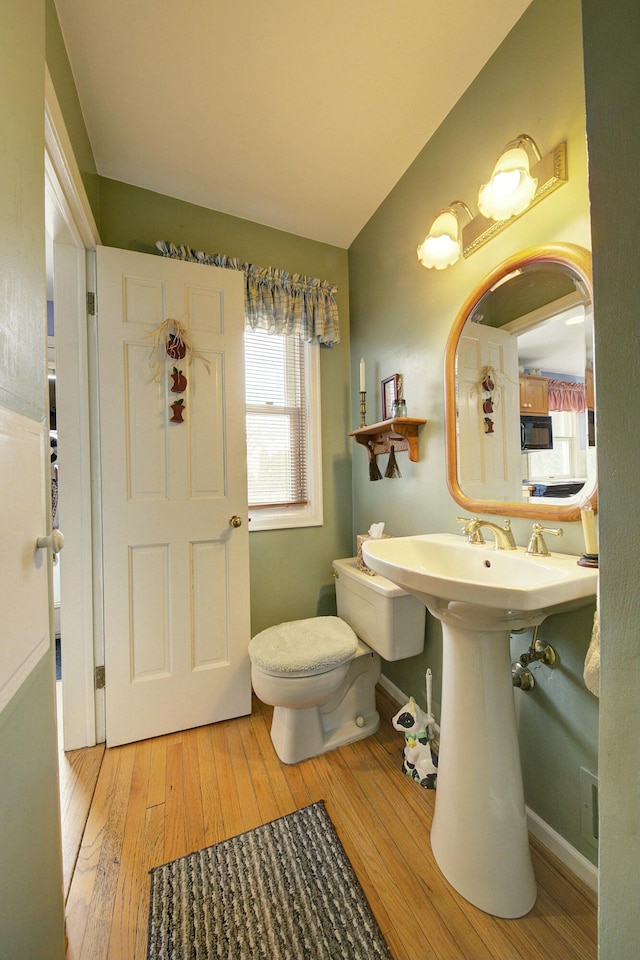 bathroom featuring vaulted ceiling, baseboards, toilet, and hardwood / wood-style floors