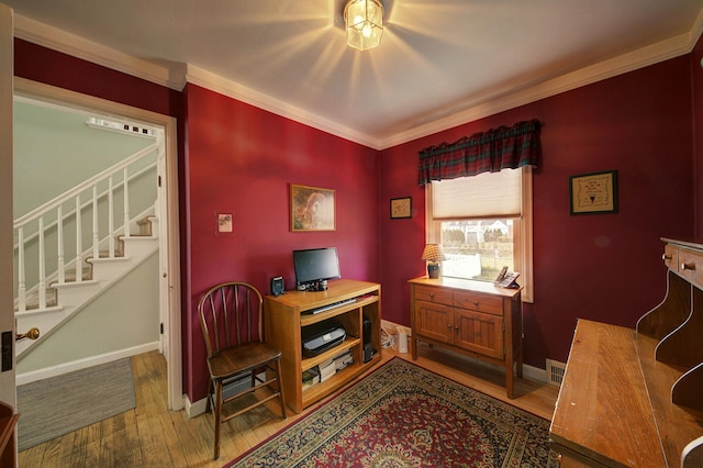 office space featuring crown molding, baseboards, and wood finished floors