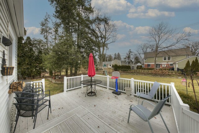 wooden terrace with a lawn