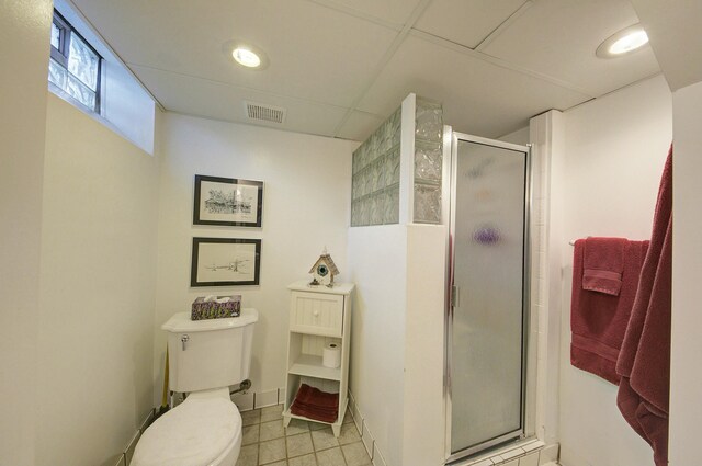 full bathroom with visible vents, toilet, a shower stall, baseboards, and tile patterned floors