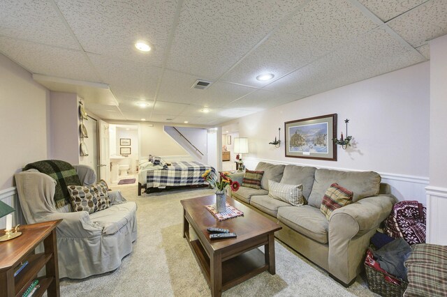 living area featuring carpet floors, recessed lighting, visible vents, and a drop ceiling