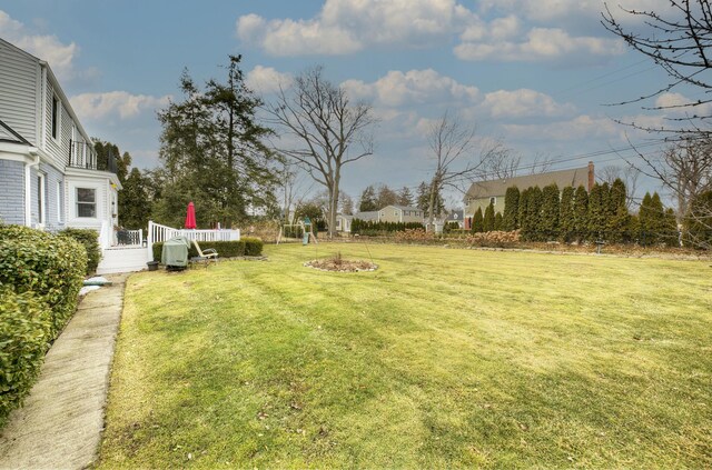 view of yard featuring a fire pit and a deck