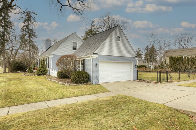 view of property exterior with driveway, brick siding, fence, and a yard